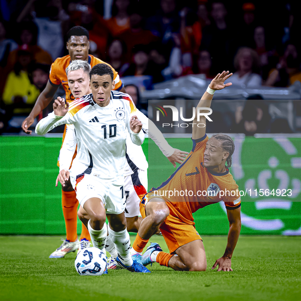 Germany midfielder Jamal Musiala and Netherlands midfielder Xavi Simons during the match between the Netherlands and Germany at the Johan Cr...