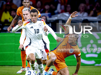 Germany midfielder Jamal Musiala and Netherlands midfielder Xavi Simons during the match between the Netherlands and Germany at the Johan Cr...