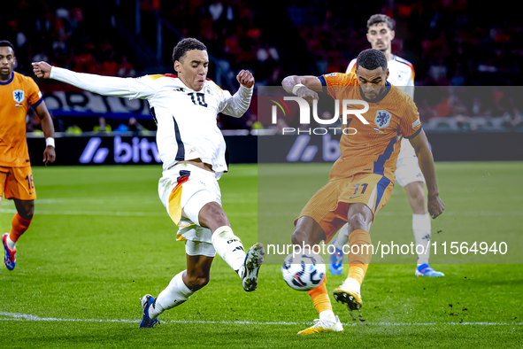 Germany midfielder Jamal Musiala and Netherlands forward Cody Gakpo during the match between the Netherlands and Germany at the Johan Cruijf...