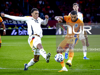 Germany midfielder Jamal Musiala and Netherlands forward Cody Gakpo during the match between the Netherlands and Germany at the Johan Cruijf...