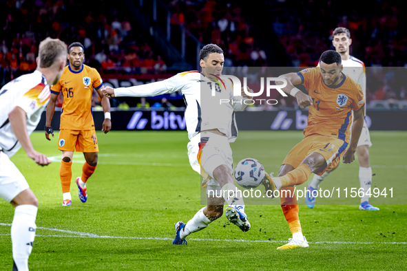 Germany midfielder Jamal Musiala and Netherlands forward Cody Gakpo during the match between the Netherlands and Germany at the Johan Cruijf...