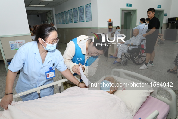 A volunteer in the unaccompanied ward of Shaoxing Central Hospital in Shaoxing, China, on September 10, 2024, waits for a B-ultrasound exami...