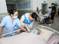 A volunteer in the unaccompanied ward of Shaoxing Central Hospital in Shaoxing, China, on September 10, 2024, waits for a B-ultrasound exami...