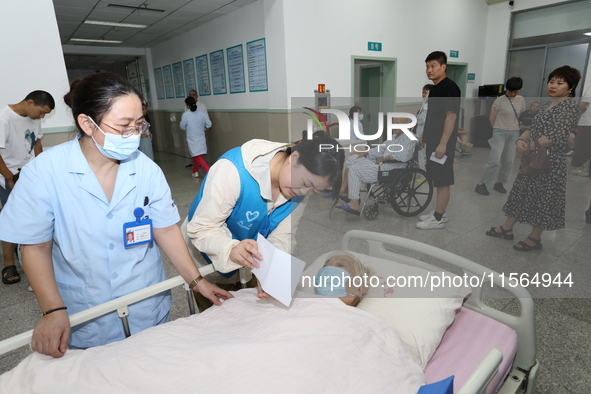 A volunteer in the unaccompanied ward of Shaoxing Central Hospital in Shaoxing, China, on September 10, 2024, waits for a B-ultrasound exami...