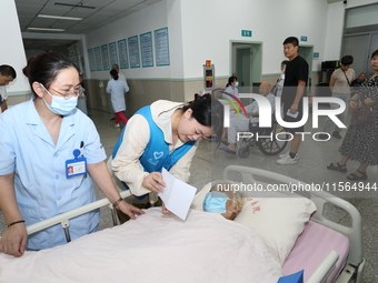 A volunteer in the unaccompanied ward of Shaoxing Central Hospital in Shaoxing, China, on September 10, 2024, waits for a B-ultrasound exami...