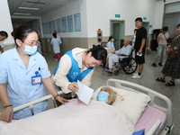 A volunteer in the unaccompanied ward of Shaoxing Central Hospital in Shaoxing, China, on September 10, 2024, waits for a B-ultrasound exami...