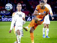 Germany midfielder Jamal Musiala and Netherlands forward Cody Gakpo during the match between the Netherlands and Germany at the Johan Cruijf...