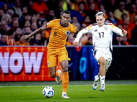 Netherlands midfielder Ryan Gravenberch and Germany midfielder Florian Wirtz during the match between the Netherlands and Germany at the Joh...