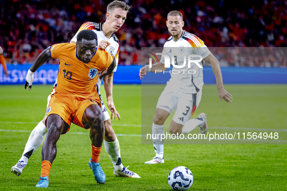 Germany defender Nico Schlotterbeck and Netherlands forward Brian Brobbey during the match between Netherlands and Germany at the Johan Crui...