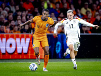 Netherlands midfielder Ryan Gravenberch and Germany midfielder Florian Wirtz during the match between the Netherlands and Germany at the Joh...