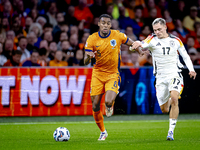 Netherlands midfielder Ryan Gravenberch and Germany midfielder Florian Wirtz during the match between the Netherlands and Germany at the Joh...