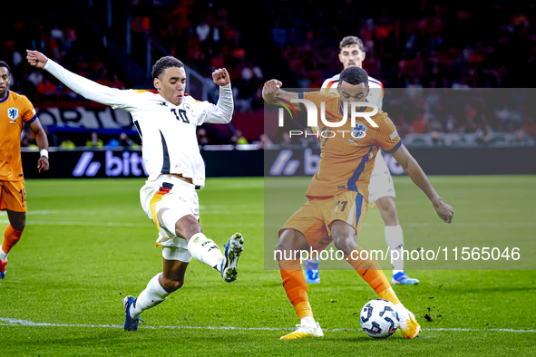 Germany midfielder Jamal Musiala and Netherlands forward Cody Gakpo during the match between the Netherlands and Germany at the Johan Cruijf...