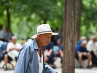 Elderly people relax at a park on Lindai Road in Fuyang, China, on September 11, 2024. (