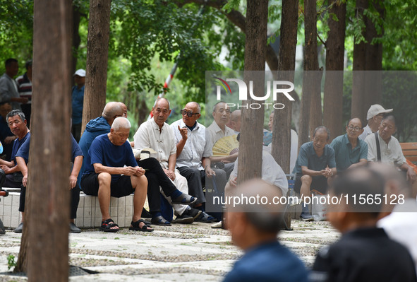 Elderly people relax at a park on Lindai Road in Fuyang, China, on September 11, 2024. 