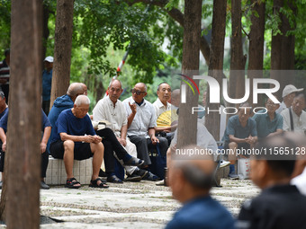 Elderly people relax at a park on Lindai Road in Fuyang, China, on September 11, 2024. (