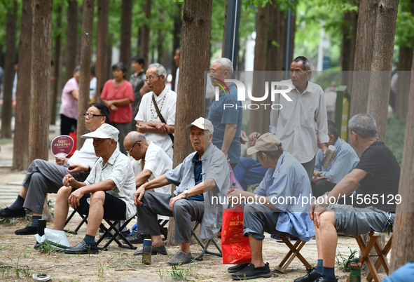 Elderly people relax at a park on Lindai Road in Fuyang, China, on September 11, 2024. 