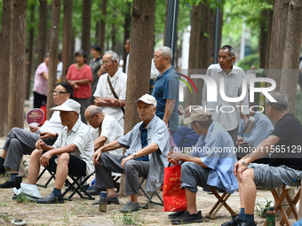 Elderly people relax at a park on Lindai Road in Fuyang, China, on September 11, 2024. (