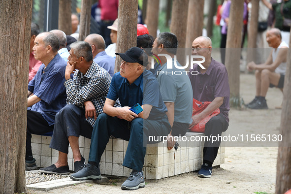 Elderly people relax at a park on Lindai Road in Fuyang, China, on September 11, 2024. 