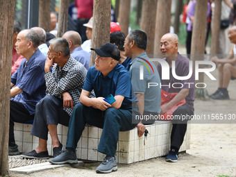 Elderly people relax at a park on Lindai Road in Fuyang, China, on September 11, 2024. (