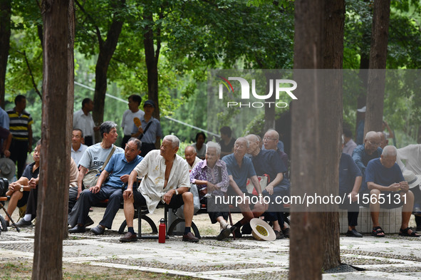 Elderly people relax at a park on Lindai Road in Fuyang, China, on September 11, 2024. 