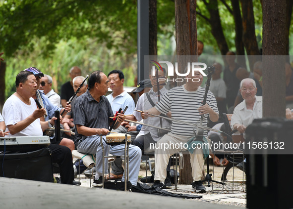 Elderly people relax at a park on Lindai Road in Fuyang, China, on September 11, 2024. 