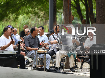 Elderly people relax at a park on Lindai Road in Fuyang, China, on September 11, 2024. (