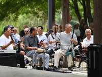 Elderly people relax at a park on Lindai Road in Fuyang, China, on September 11, 2024. (