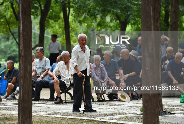 Elderly people relax at a park on Lindai Road in Fuyang, China, on September 11, 2024. 