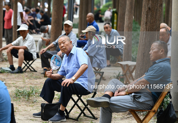 Elderly people relax at a park on Lindai Road in Fuyang, China, on September 11, 2024. 