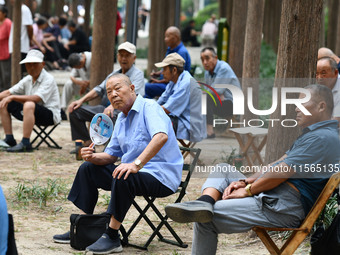 Elderly people relax at a park on Lindai Road in Fuyang, China, on September 11, 2024. (