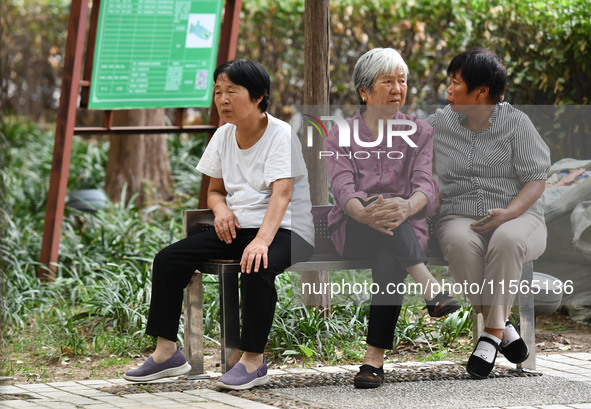 Elderly people relax at a park on Lindai Road in Fuyang, China, on September 11, 2024. 