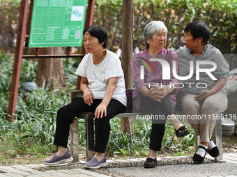 Elderly people relax at a park on Lindai Road in Fuyang, China, on September 11, 2024. (