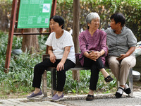 Elderly people relax at a park on Lindai Road in Fuyang, China, on September 11, 2024. (