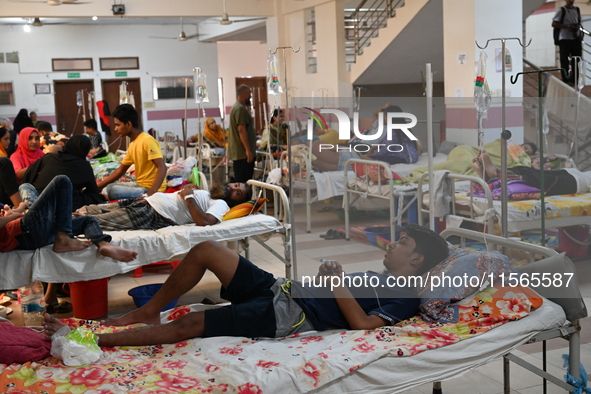 Patients suffering from dengue fever receive treatment inside the Mugdha General Hospital's admission section in Dhaka, Bangladesh, on Septe...