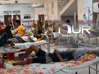 Patients suffering from dengue fever receive treatment inside the Mugdha General Hospital's admission section in Dhaka, Bangladesh, on Septe...