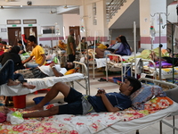 Patients suffering from dengue fever receive treatment inside the Mugdha General Hospital's admission section in Dhaka, Bangladesh, on Septe...