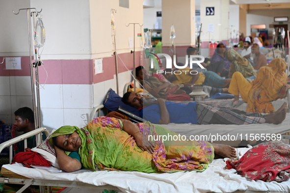 Patients suffering from dengue fever receive treatment inside the Mugdha General Hospital's admission section in Dhaka, Bangladesh, on Septe...