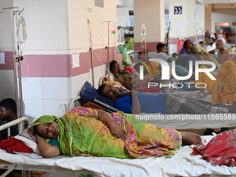 Patients suffering from dengue fever receive treatment inside the Mugdha General Hospital's admission section in Dhaka, Bangladesh, on Septe...