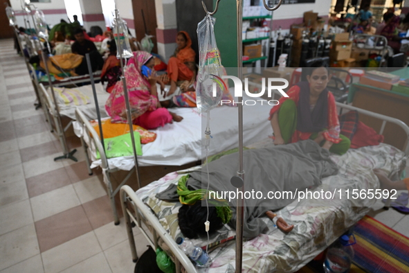 Patients suffering from dengue fever receive treatment inside the Mugdha General Hospital's admission section in Dhaka, Bangladesh, on Septe...