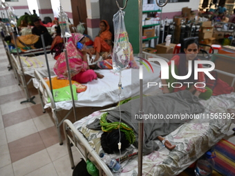 Patients suffering from dengue fever receive treatment inside the Mugdha General Hospital's admission section in Dhaka, Bangladesh, on Septe...