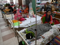 Patients suffering from dengue fever receive treatment inside the Mugdha General Hospital's admission section in Dhaka, Bangladesh, on Septe...