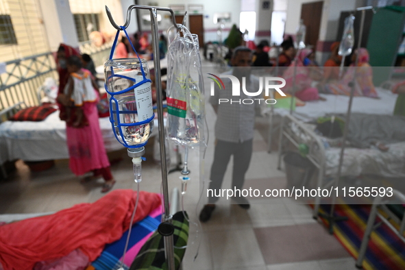 Patients suffering from dengue fever receive treatment inside the Mugdha General Hospital's admission section in Dhaka, Bangladesh, on Septe...