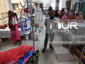 Patients suffering from dengue fever receive treatment inside the Mugdha General Hospital's admission section in Dhaka, Bangladesh, on Septe...