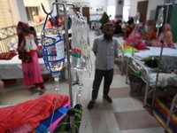 Patients suffering from dengue fever receive treatment inside the Mugdha General Hospital's admission section in Dhaka, Bangladesh, on Septe...