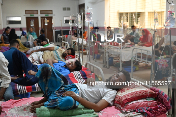 Patients suffering from dengue fever receive treatment inside the Mugdha General Hospital's admission section in Dhaka, Bangladesh, on Septe...