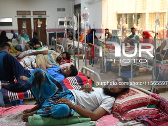 Patients suffering from dengue fever receive treatment inside the Mugdha General Hospital's admission section in Dhaka, Bangladesh, on Septe...