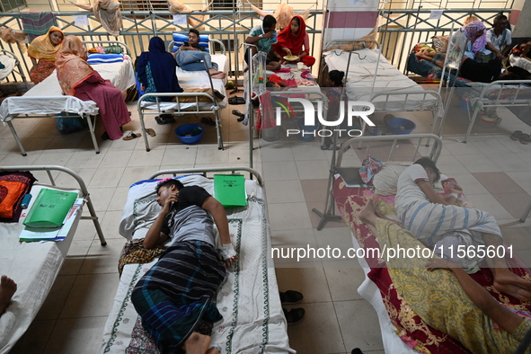 Patients suffering from dengue fever receive treatment inside the Mugdha General Hospital's admission section in Dhaka, Bangladesh, on Septe...