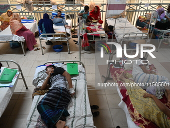 Patients suffering from dengue fever receive treatment inside the Mugdha General Hospital's admission section in Dhaka, Bangladesh, on Septe...