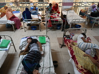 Patients suffering from dengue fever receive treatment inside the Mugdha General Hospital's admission section in Dhaka, Bangladesh, on Septe...