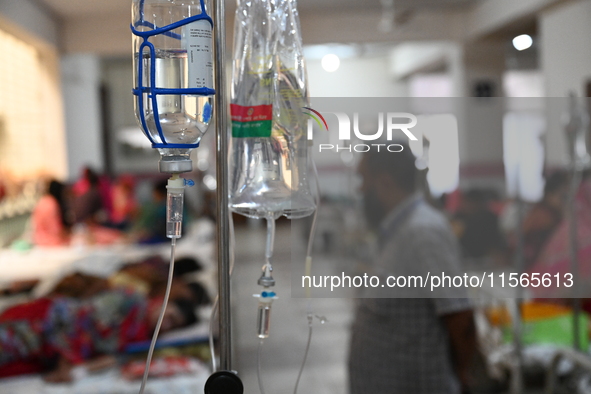 Patients suffering from dengue fever receive treatment inside the Mugdha General Hospital's admission section in Dhaka, Bangladesh, on Septe...